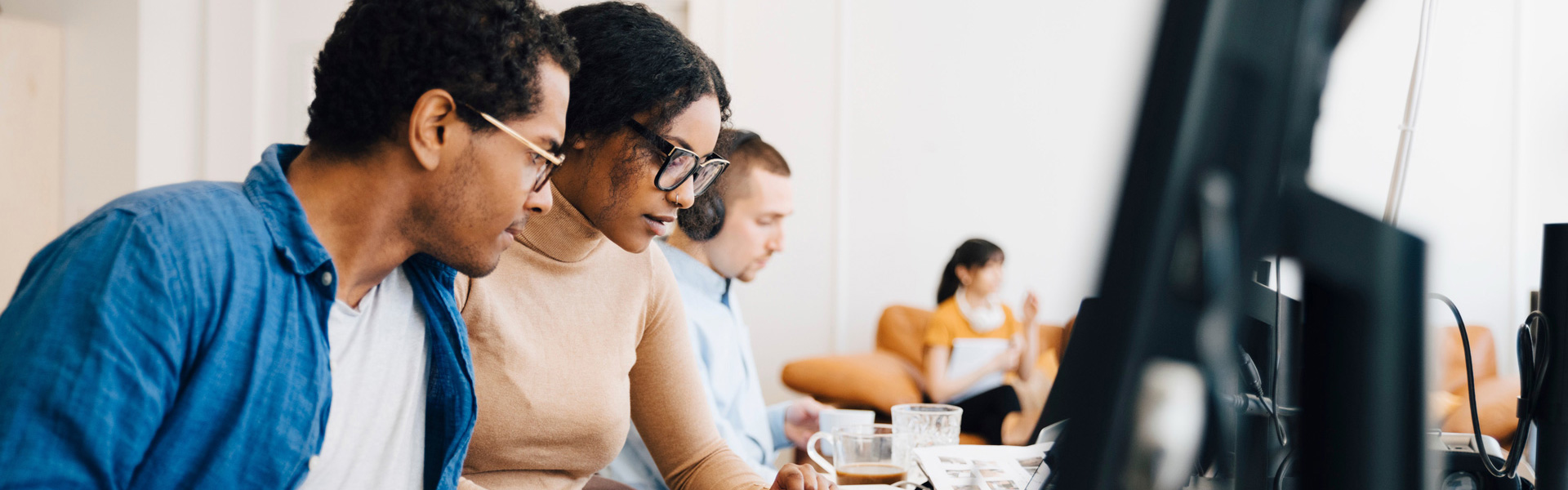 Team of IT and security consultants working in the office on their monitors