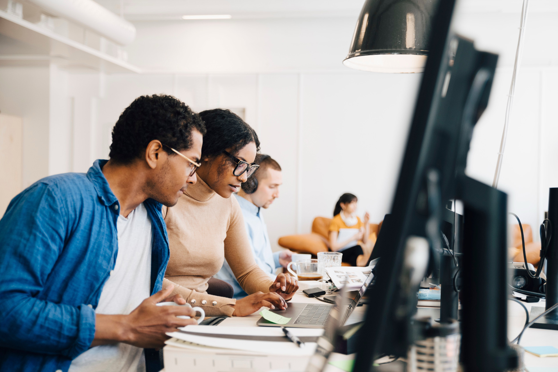 IT-team Team of IT and security consultants working in the office on their monitors