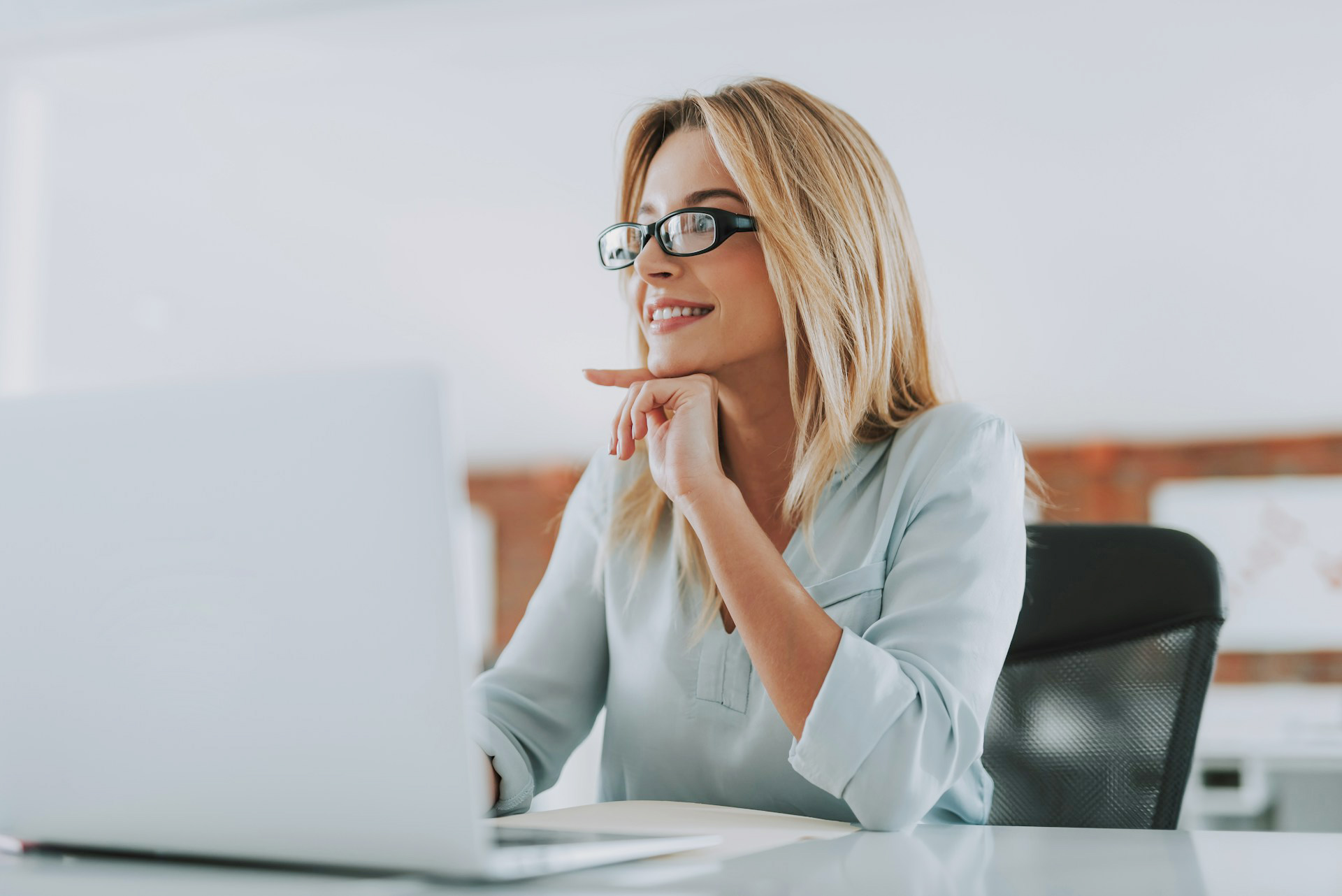 Female sitting at her desk working on compliance